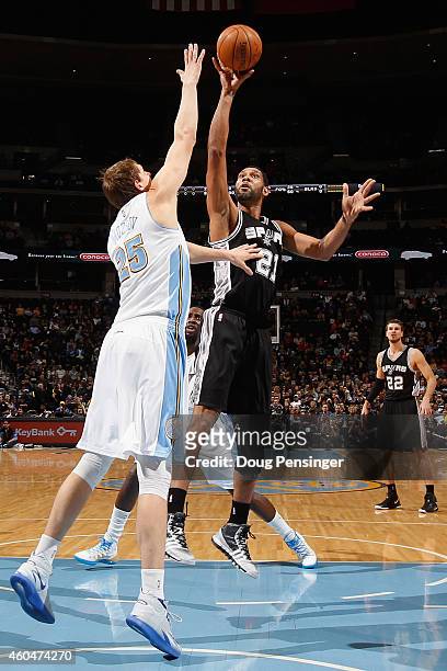 Tim Duncan of the San Antonio Spurs takes a shot over Timofey Mozgov of the Denver Nuggets at Pepsi Center on December 14, 2014 in Denver, Colorado....