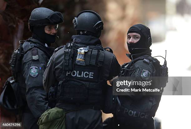 Armed policeman talk on Phillip St close to Martin Place on December 15, 2014 in Sydney, Australia. Police attend a hostage situation at Lindt Cafe...