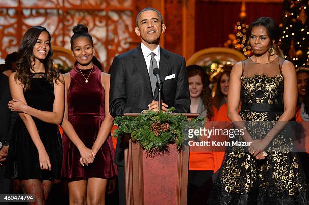 Malia Obama, Sasha Obama, U.S. President Barack Obama, and First Lady Michelle Obama speak onstage at TNT Christmas in Washington 2014 at the...