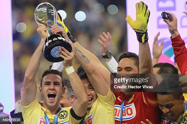 Miguel Layun, Rubens Sambueza and Moises Munoz of America raise the champions trophy after a Final second leg match between America and Tigres UANL...