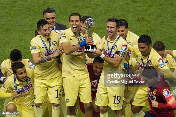 Jesús Molina and Miguel Layún of America lift the trophy after winning the final second leg match between America and Tigres UANL as part of the...