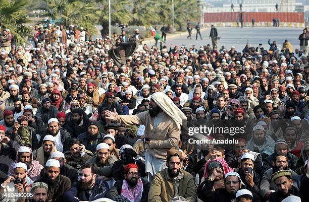 Pakistani Sunni Muslim shouts slogans and some others watch the funeral ceremony of Munir Ahmedi, secretary-general of Sunni Muslim group, and a...