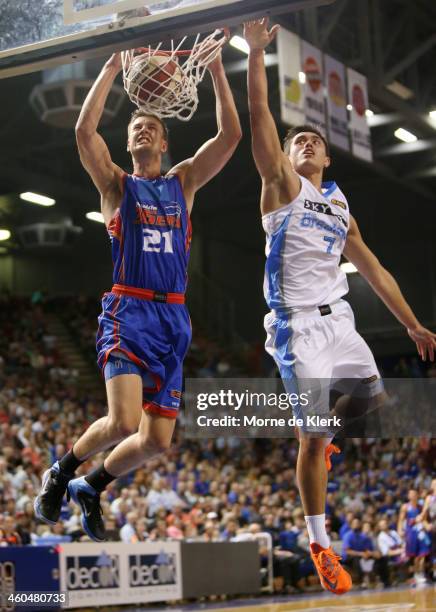 Daniel Johnson of the 36ers dunks the ball under pressure from Brendan Teys of the Breakers during the round 12 NBL match between the Adelaide 36ers...