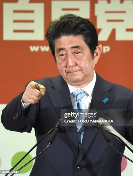 Japanese Prime Minister and President of the ruling Liberal Democratic Party Shinzo Abe points to a journalist during a press conference at the...
