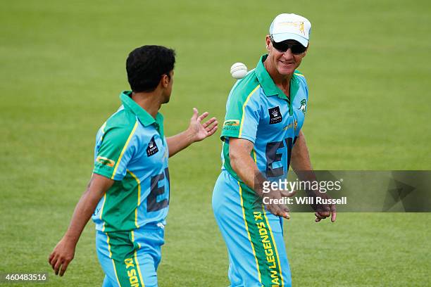 Andy Bichel of the Legends XI throws the ball to Yasir Arafat during the Twenty20 match between the Perth Scorchers and Australian Legends at Aquinas...