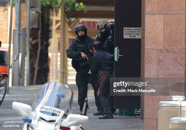Hostage runs to safety outside the Lindt Cafe, Martin Place on December 15, 2014 in Sydney, Australia. Police attend a hostage situation at Lindt...