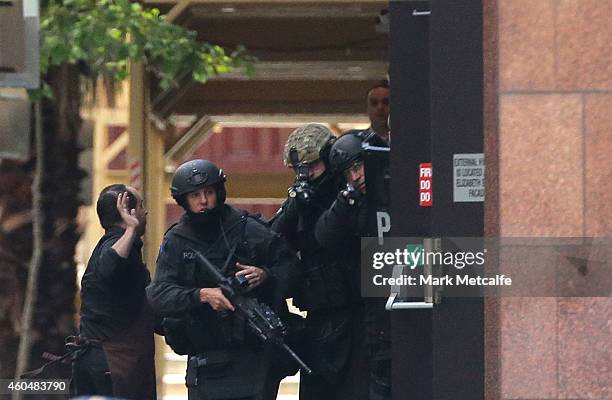 Hostage runs to safety outside the Lindt Cafe, Martin Place on December 15, 2014 in Sydney, Australia. Police attend a hostage situation at Lindt...