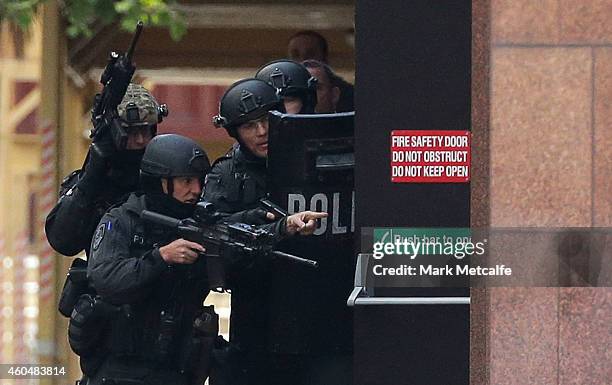 Armed police are seen outside the Lindt Cafe, Martin Place on December 15, 2014 in Sydney, Australia. Police attend a hostage situation at Lindt Cafe...