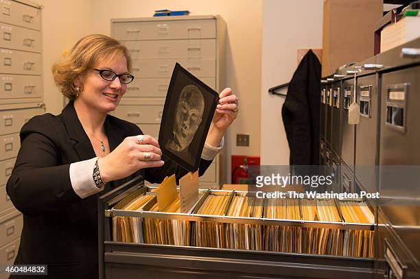 Cory Grace, Rights and Reproductions Coordinator/Digital Assistant at the Freer/Sackler Galleries, pulls an 8X10 transparency from the files in the...