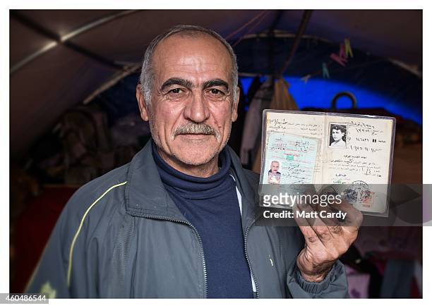 Iraqi Christian Najeeb Mansoor poses for a photograph in his tented home erected in the grounds of Mazar Mar Eillia Catholic Church, that has now...