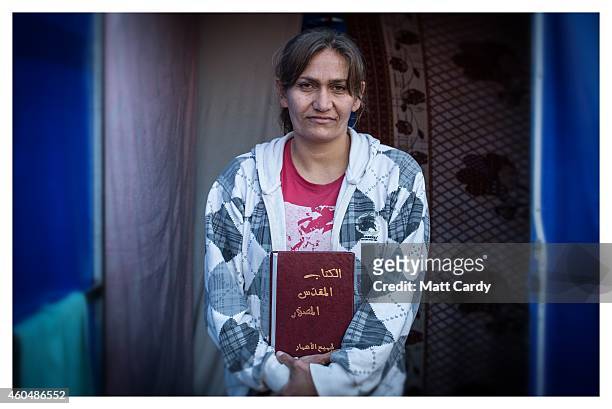 Iraqi Christian, Heleen Dawood, poses for a photograph in her tented home erected in the grounds of Mazar Mar Eillia Catholic Church, that has now...
