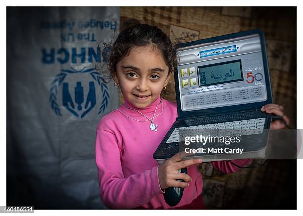 Iraqi Christian, 6-year-old Fatin Atheer, poses for a photograph in her tented home erected in the grounds of Mazar Mar Eillia Catholic Church, that...