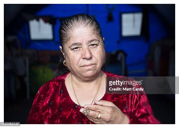 Iraqi Christian Shony Franso poses for a photograph in her tented home erected in the grounds of Mazar Mar Eillia Catholic Church, that has now...