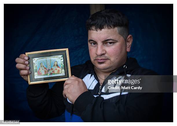 Iraqi Christian, Khidhir Badry, poses for a photograph in his tented home erected in the grounds of Mazar Mar Eillia Catholic Church, that has now...