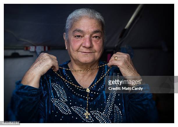 Iraqi Christian, Jandark Jibrael, poses for a photograph in her tented home erected in the grounds of Mazar Mar Eillia Catholic Church, that has now...