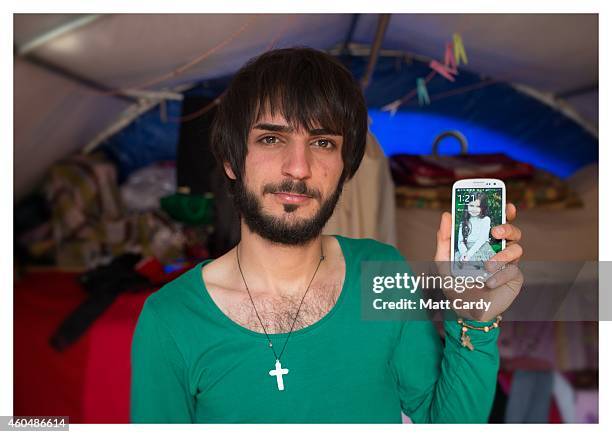 Iraqi Christian Anas Khaleel poses for a photograph in his tented home erected in the grounds of Mazar Mar Eillia Catholic Church, that has now...