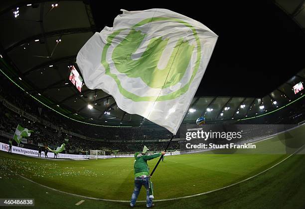 Wolfsburg fan waves a big flag prior to the Bundesliga match between VfL Wolfsburg and SC Paderborn 07 at Volkswagen Arena on December 14, 2014 in...