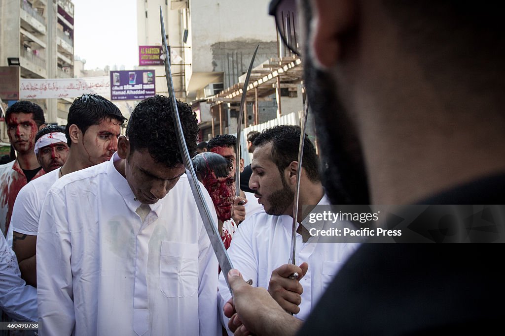 Male Shia Muslim participates in ceremonial chest beating...