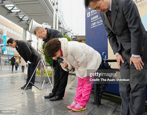 Rie Yoshida of the Democratic Party of Japan and her staffs bow to passers-by a day after the defeat in lower house election Gifu No.1 constituency...