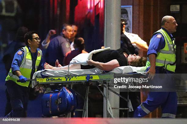 Person is taken out on a stretcher from the Lindt Cafe, Martin Place following a hostage standoff on December 16, 2014 in Sydney, Australia. Polie...