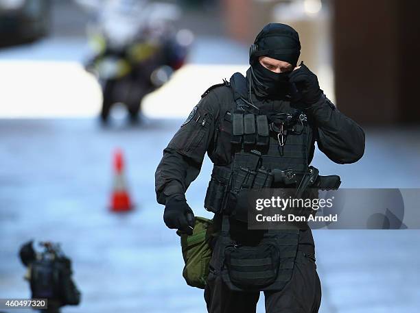 An armed policeman walks northward along Philip St , Martin Place on December 15, 2014 in Sydney, Australia. Police attend a hostage situation at...