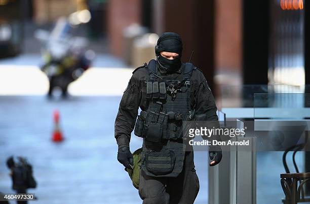 An armed policeman walks northward along Philip St , Martin Place on December 15, 2014 in Sydney, Australia. Police attend a hostage situation at...