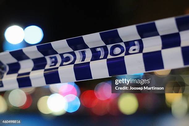 Police tape is streched near the Lindt Chocolate Cafe in Martin Place following a hostage standoff on December 16, 2014 in Sydney, Australia. Two...