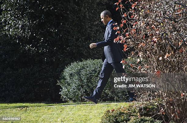 President Barack Obama departs the White House in Washington, DC, December 15, 2014. Barack Obama is travelling to Joint Base McGuire-Dix-Lakehurst...