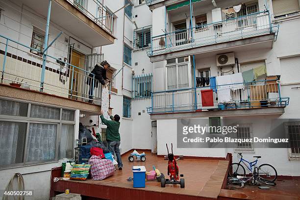 Mercedes Pincay passes her ironing board to a friend out of her home as she waits for her eviction to take place on December 15, 2014 in Madrid,...