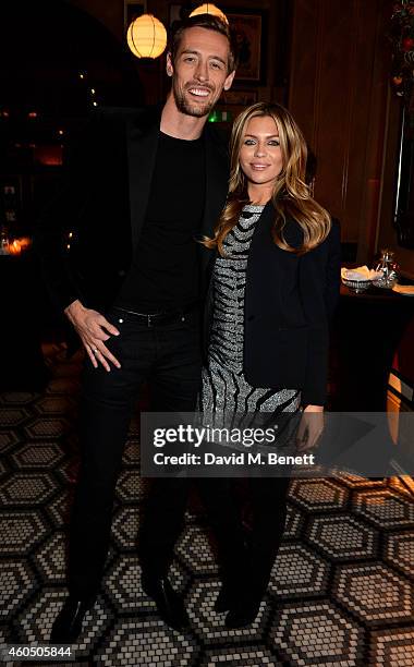 Footballer Peter Crouch and his wife model Abbey Clancy attend the LOVE x Balmain Xmas Party at The Ivy Market Grill on December 15, 2014 in London,...