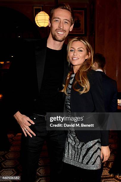 Footballer Peter Crouch and his wife model Abbey Clancy attend the LOVE x Balmain Xmas Party at The Ivy Market Grill on December 15, 2014 in London,...