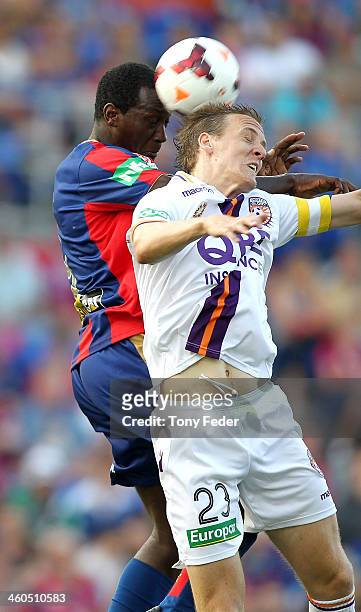 Michael Thwaite of the Glory contests a header with Emile Heskey of the Jets during the round 13 A-League match between the Newcastle Jets and Perth...