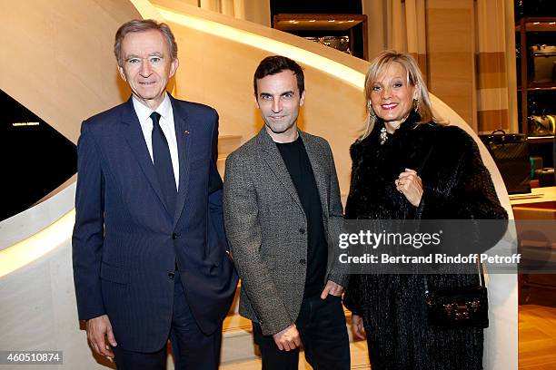 Fashion Designer of Louis Vuitton, Nicolas Ghesquiere standing between Owner of LVMH Luxury Group Bernard Arnault and his wife Helene Arnault attend...