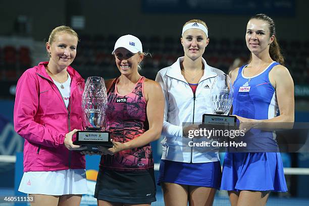 Alla Kudryavtseva of Russia and Anastasia Rodionova of Australia hold up the winners trophy while Kristina Mladnovic of France and Galina Voskoboeva...