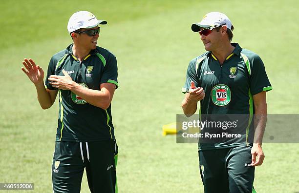 Peter Siddle and Ryan Harris of Australia warm up during an Australian Nets Session at The Gabba on December 16, 2014 in Brisbane, Australia.