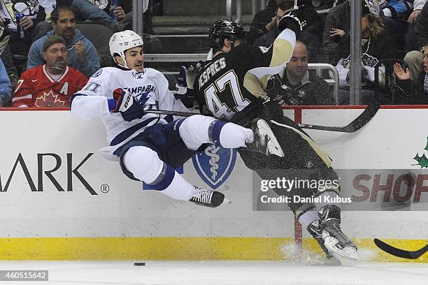 Simon Despres of the Pittsburgh Penguins hits Brian Boyle of the Tampa Bay Lightning in the second period at Consol Energy Center on December 15,...