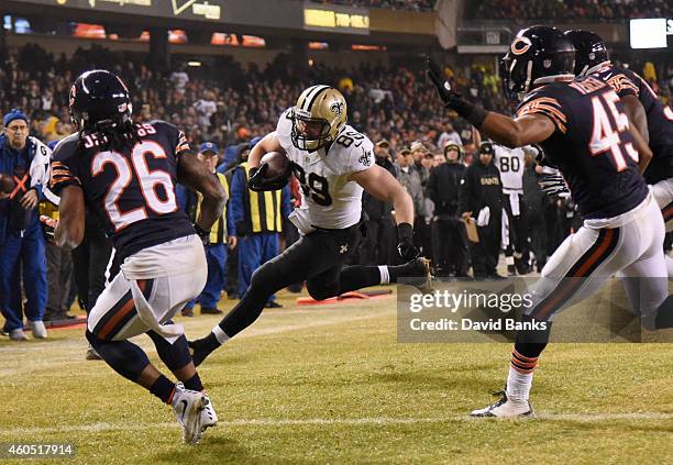 Josh Hill of the New Orleans Saints heads into the end zone for a touchdown as Tim Jennings and Brock Vereen of the Chicago Bears defend during the...