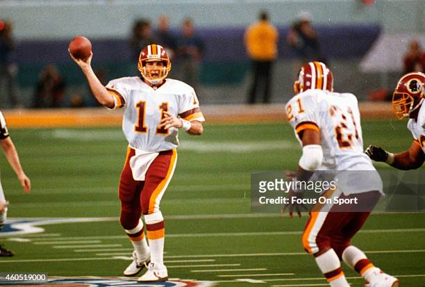 Mark Rypien of the Washington Redskins looks to pass to Earnest Byner against the Buffalo Bills during Super Bowl XXVI at the Metrodome in...