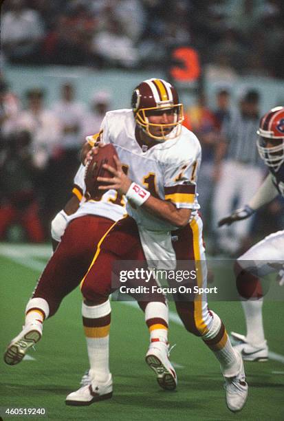 Mark Rypien of the Washington Redskins drops back to pass against the Buffalo Bills during Super Bowl XXVI at the Metrodome in Minneapolis, Minnesota...