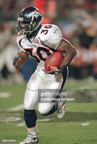 Terrell Davis of the Denver Broncos carries the ball against the Atlanta Falcons during Super Bowl XXXIII January 31, 1999 at Pro Player Stadium in...