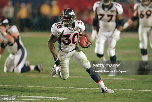 Terrell Davis of the Denver Broncos carries the ball against the Atlanta Falcons during Super Bowl XXXIII January 31, 1999 at Pro Player Stadium in...