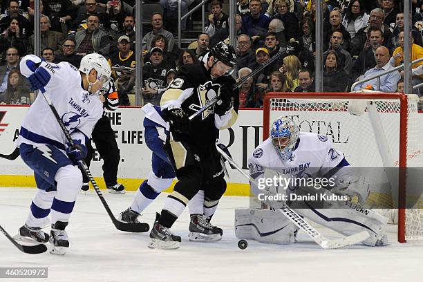 Nick Spaling of the Pittsburgh Penguins fights for a loose puck in front of Evgeni Nabokov of the Tampa Bay Lightning in the third period at Consol...