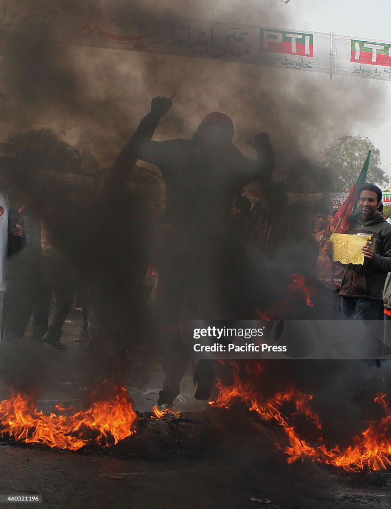 Supporters join and burn tires during the protest led by the...