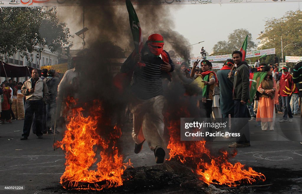 Supporters join and burn tires during the protest led by the...