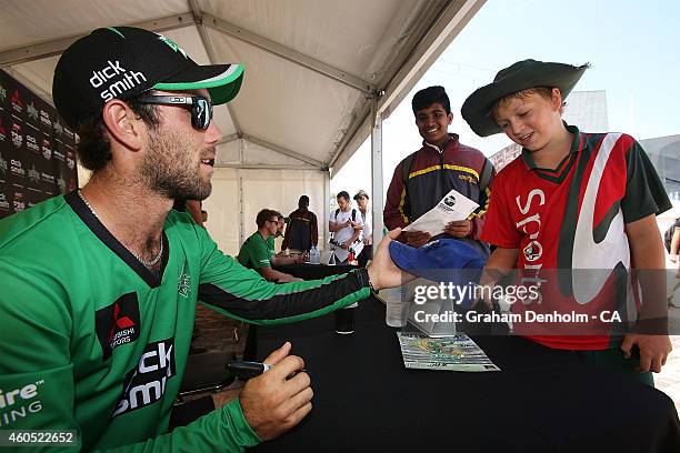 Glenn Maxwell of the Melbourne Stars signs his autograph for a young fan during the Melbourne Stars derby launch at Federation Square on December 16,...