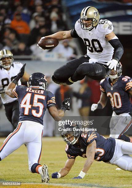 Jimmy Graham of the New Orleans Saints jumps over Kyle Fuller of the Chicago Bears and Brock Vereen of the Chicago Bears during the fourth quarter at...