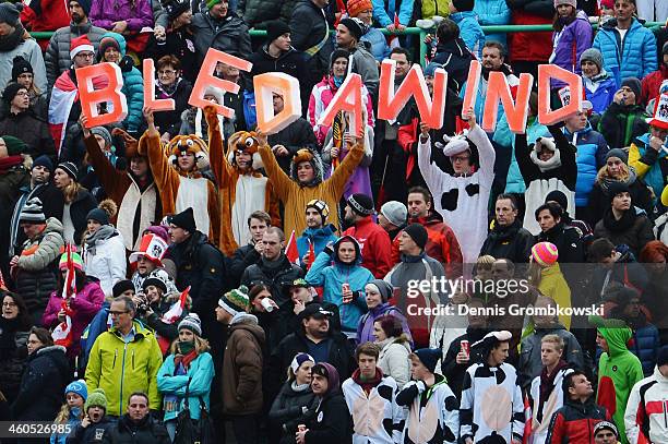 Spectators hold up letters displaying the words 'Bleda Wind' as strong winds lead to a break-off after the first competition round on day 2 of the...