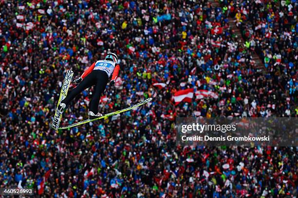 Simon Ammann of Switzerland soars through the air during his first round jump on day 2 of the Four Hills Tournament event at Bergisel on January 4,...