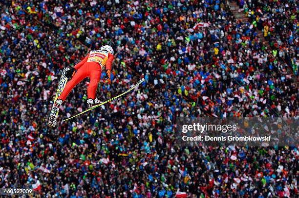 Kamil Stoch of Poland soars through the air during his first round jump on day 2 of the Four Hills Tournament event at Bergisel on January 4, 2014 in...