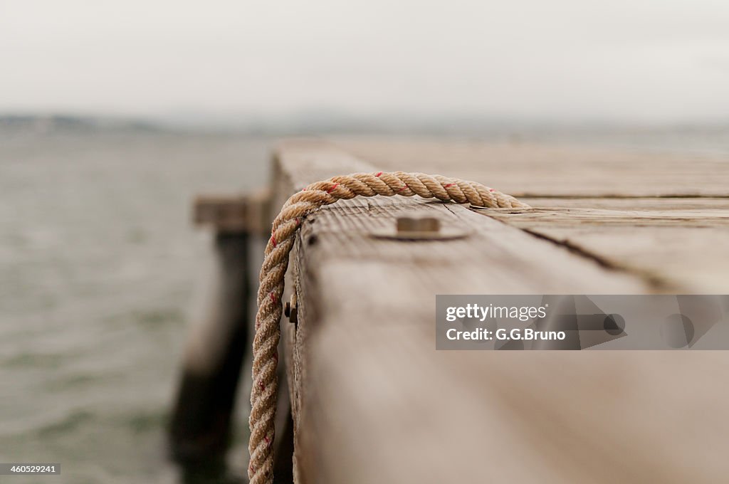 Sea view from a pontoon with focus on a rope